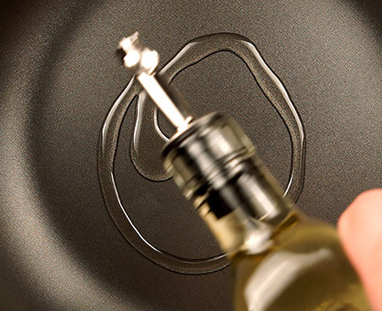 oil being poured in a pan