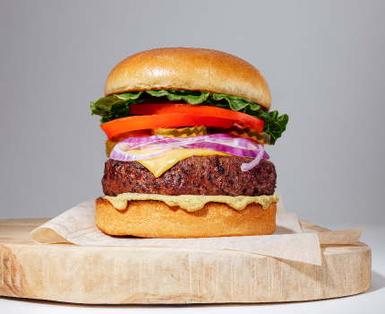 plant based burger on wooden platter