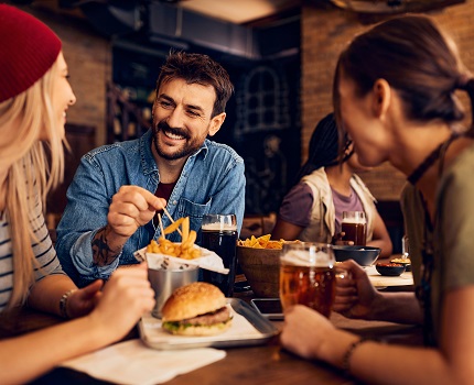 Group of friends eating fries and burger