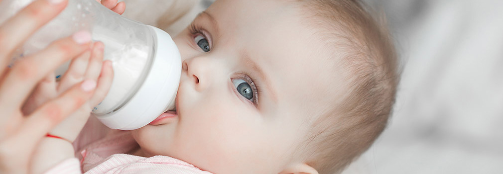 Baby nursing on a bottle