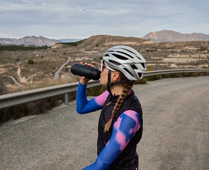 Cyclist drinking protein drink