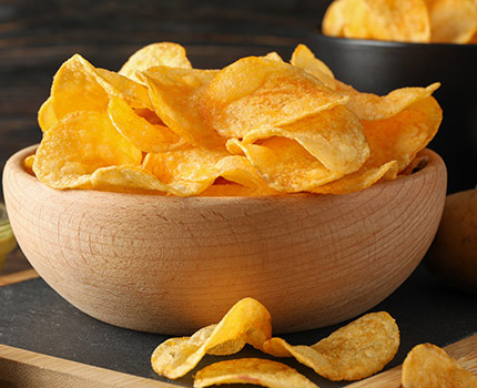 wooden bowl full with potato chips
