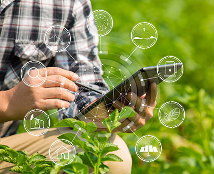 man's hands holding a tablet with sustainability icons superimposed over