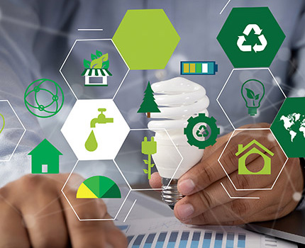 icons of sustainability topics superimposed over man writing in notebook