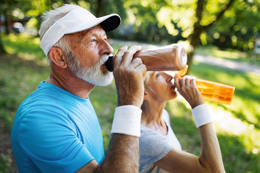 older couple drinking sports drinks