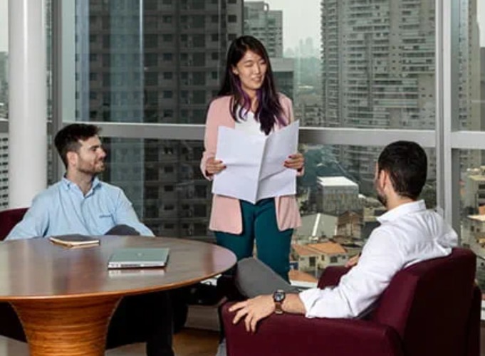 three office workers chatting