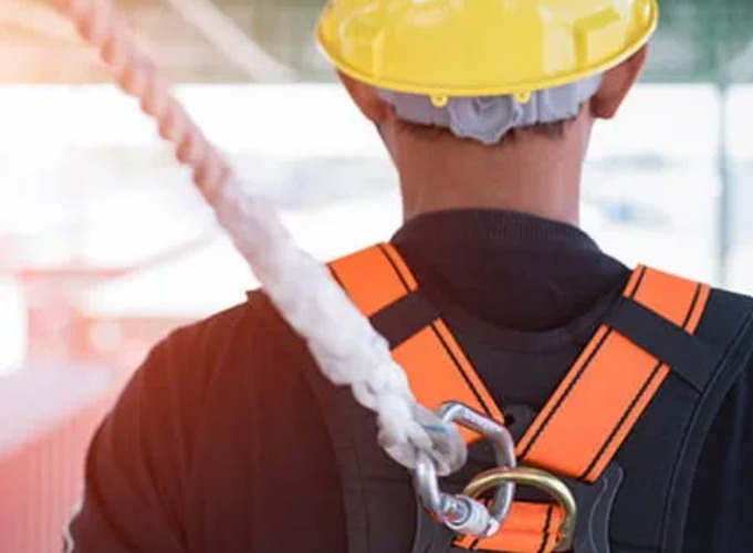 worker in hard hat and safety harness