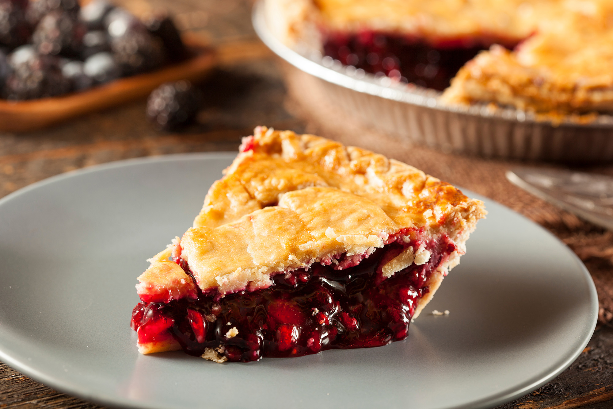 A plate with freshly sliced cherry pie.