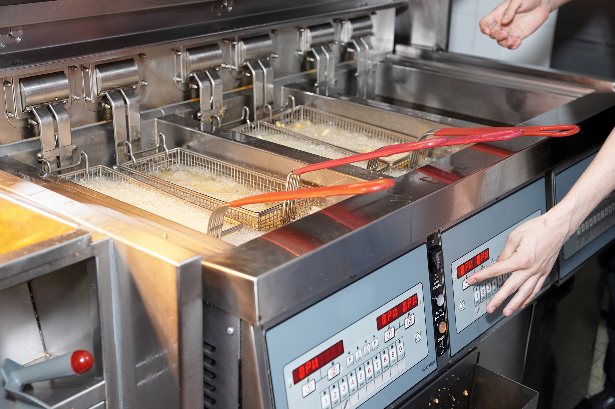 Close-up of restaurant kitchen deep fryers. 