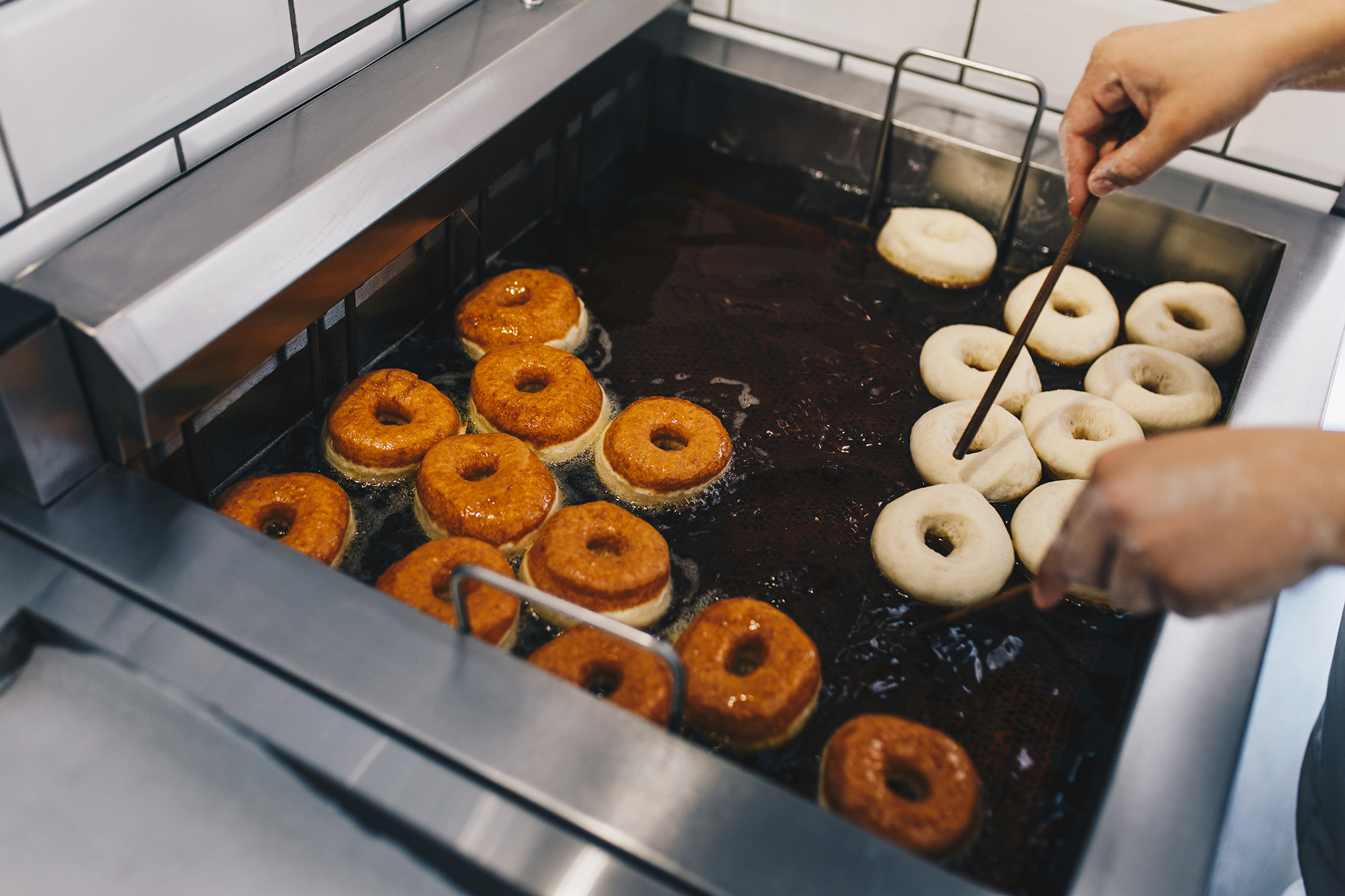 Close-up of donuts in the deep fryer. 