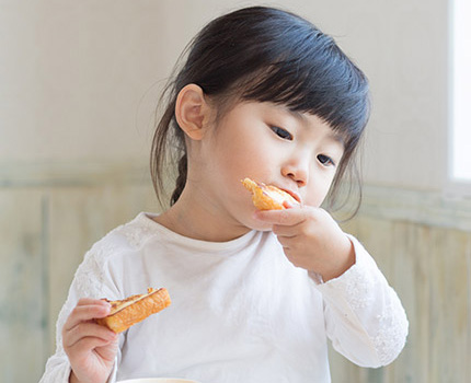 girl eating toast