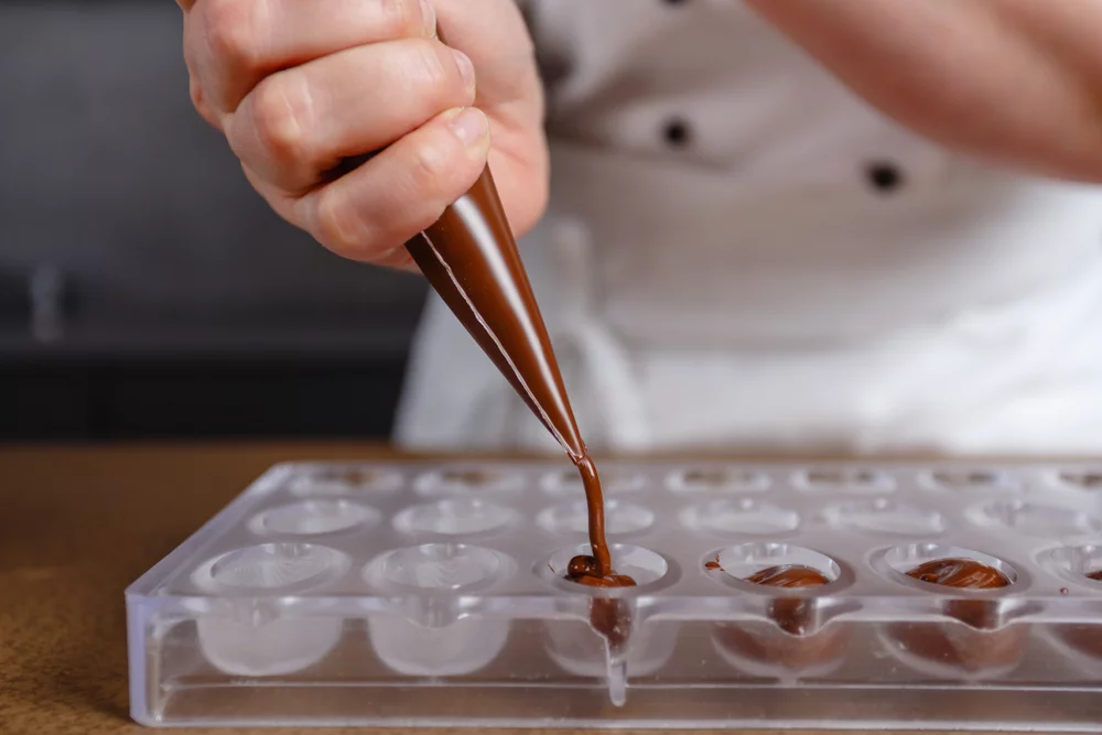 Filling the mold with chocolate