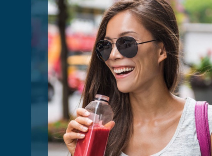 woman in sunglasses drinking blended fruit drink
