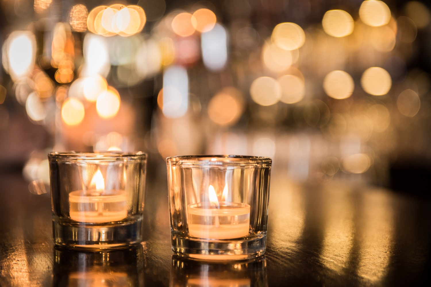 Candles burning in glass containers
